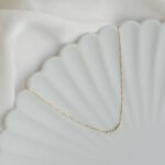 Taralynn-1-5-stone-arc-necklace-14k-model-0166-edit-cropped-final-v2-2